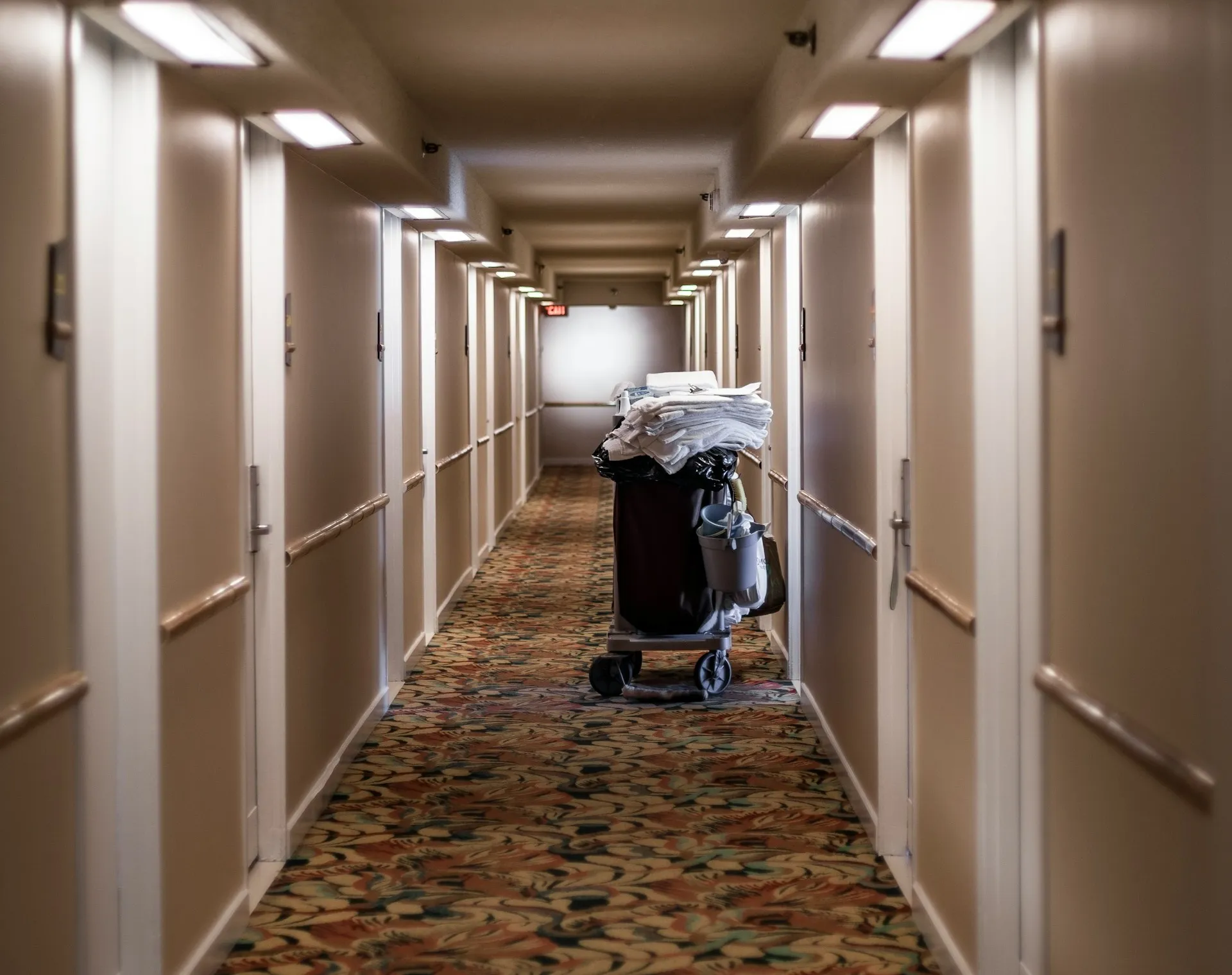 Housekeeping cart with liners in hotel hallway